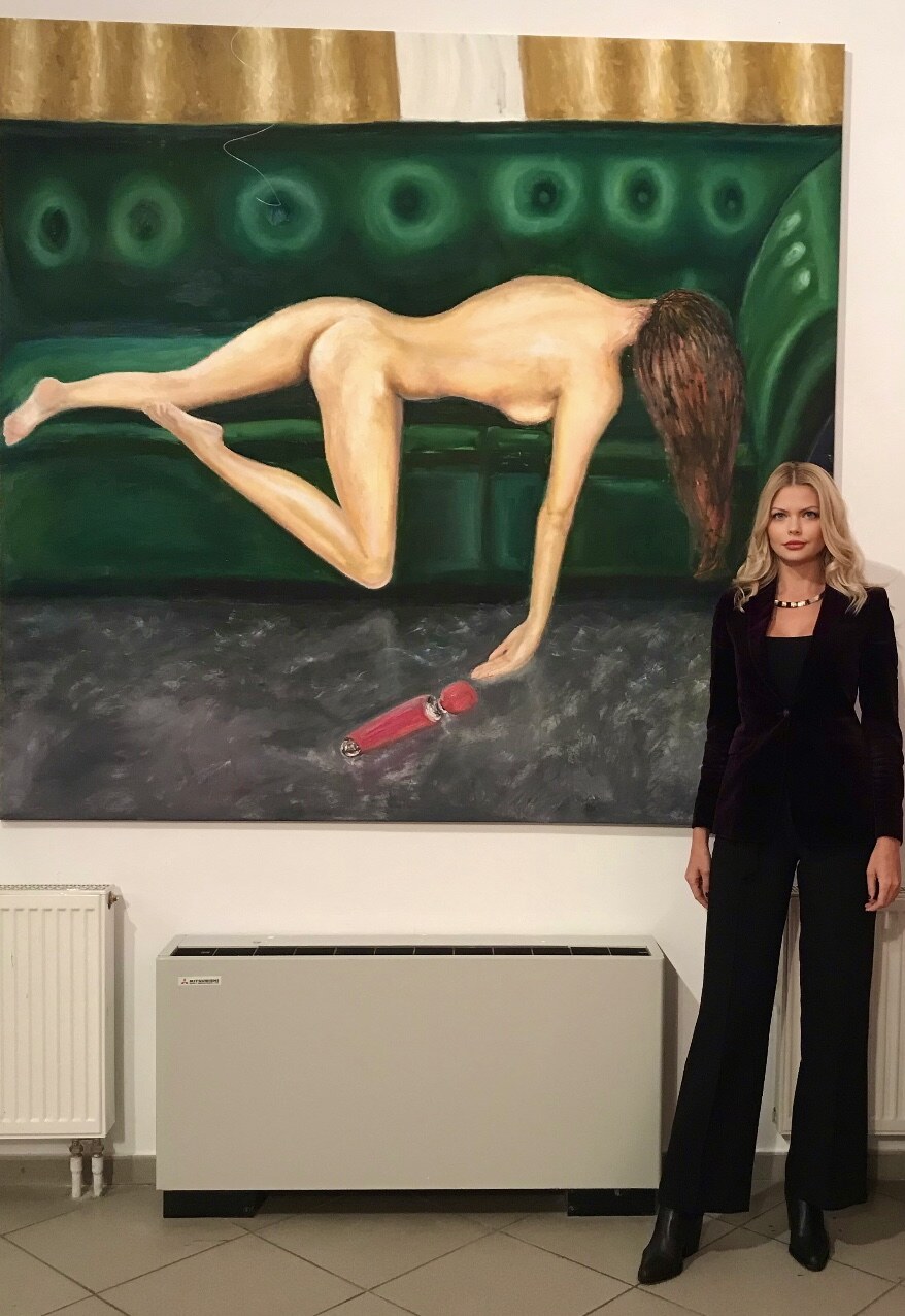 Aleksandra Klitina beside one of her paintings